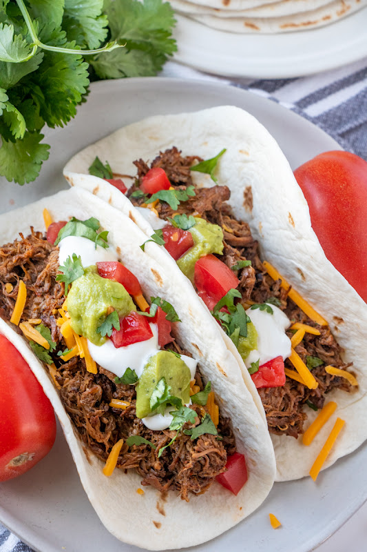 Let the slow cooker do all the work for you with this meal! Perfect for dinner and the leftovers are great for quesadillas, burritos, taco salads and more! This Mexican shredded beef is packed full of flavor from cilantro, cumin, garlic, bell pepper, onion and more!