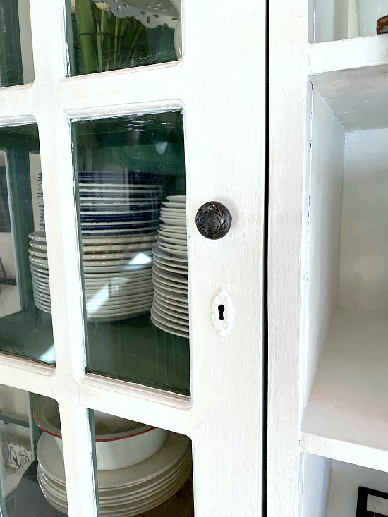 White farmhouse hutch with glass doors.