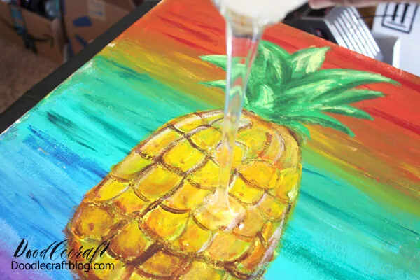Next, pour the mixed resin on the center of the canvas. Use a clean stirring stick to gently smooth the resin close to all the edges. Some run-off may occur. 