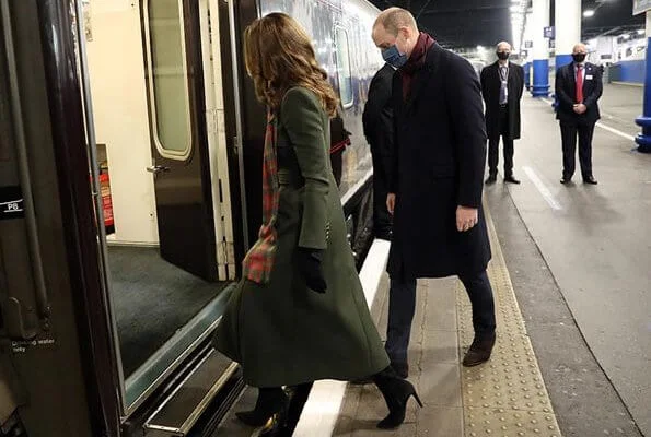 Kate Middleton wore a khaki coat and tartan scarf from Alexander McQueen, and blue coat and black gloves from Catherine Walker. Meghan Markle