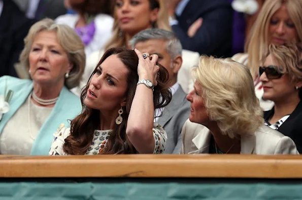 Duchess Catherine at the Men's Final of the Wimbledon. Kate Middleton wore Alexander McQueen Obsession Print Short Sleeve Dress. Brora Gold Charm Earrings, and carried her L.K. Bennett Natalie clutch.