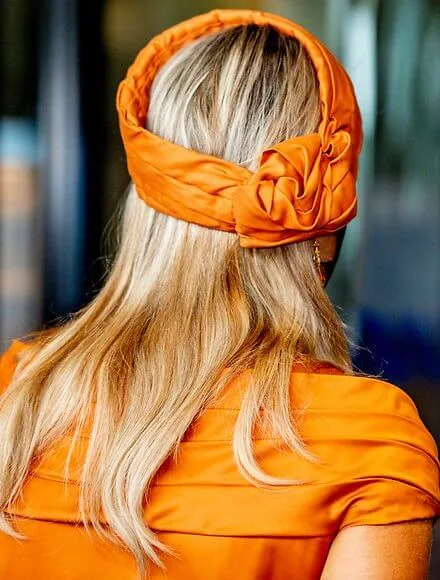 Queen Maxima wore a silk pleated dress by Mattijs van Bergen. Gold, orange pear-shaped mandarin the drop diamond citrine earrings