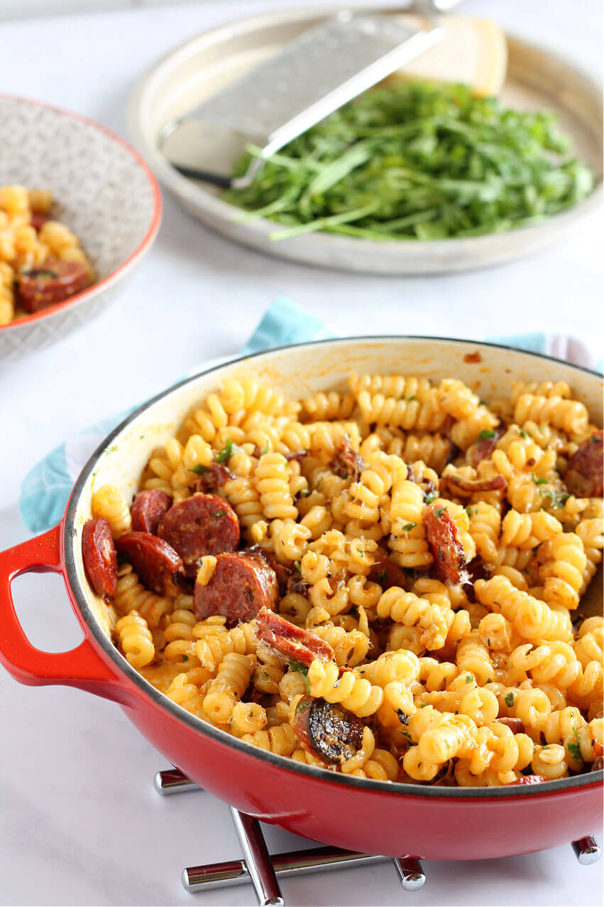 Close up of spicy chorizo pasta in a red casserole