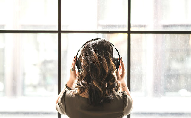 Looking out the window with headphones