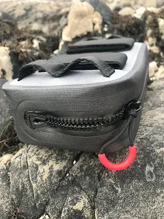 waterproof bag on rock on beach white sands 