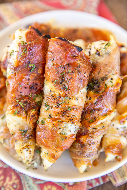 Low-Carb Prosciutto Wrapped Chicken - dangerously delicious! So simple to make with only 4 ingredients. Chicken, Italian seasoning, mozzarella cheese, and prosciutto. Ready to eat in 20 minutes! We make these at least once a month. Great with pasta, risotto, or asparagus for a Keto and low-carb friendly meal. #keto #lowcarb #glutenfree #chicken #prosciutto prosciutto wrapped chicken tenders
