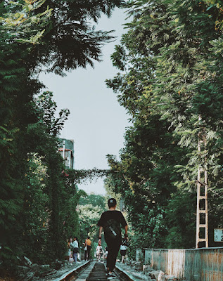 The tree-lined train road in the heart of Hanoi attracts young people
