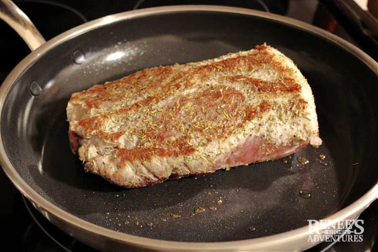 Pork ribeye roast browned in skillet on the stove