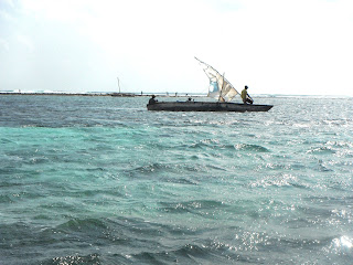 jambiani beach in zanzibar, boat with rocker landing on the reef at low tide