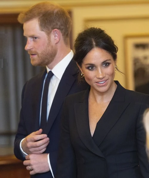 Meghan Markle wore Judith & Charles Digital Dress, Paul Andrew pumps, carried Jimmy Choo clutch. Prince Harry