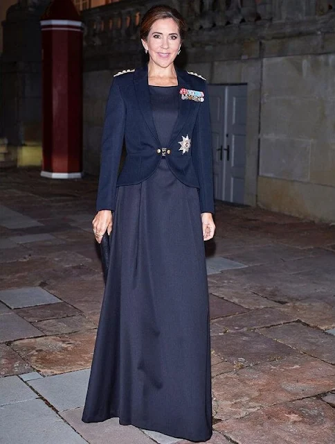 Crown Princess Mary wore the official uniform worn by Danish female navy officers. Queen Margrethe wore a lace tulle gown