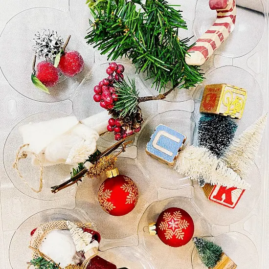 Recycled apple container filled with Christmas ornaments