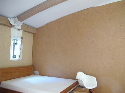 Inside rear view of a dry fit of a dolls' house shed kit, with a central wall installed.