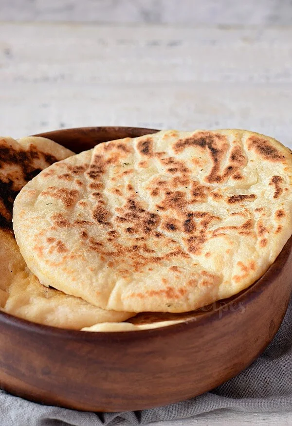 a wooden bowl with best pita bread