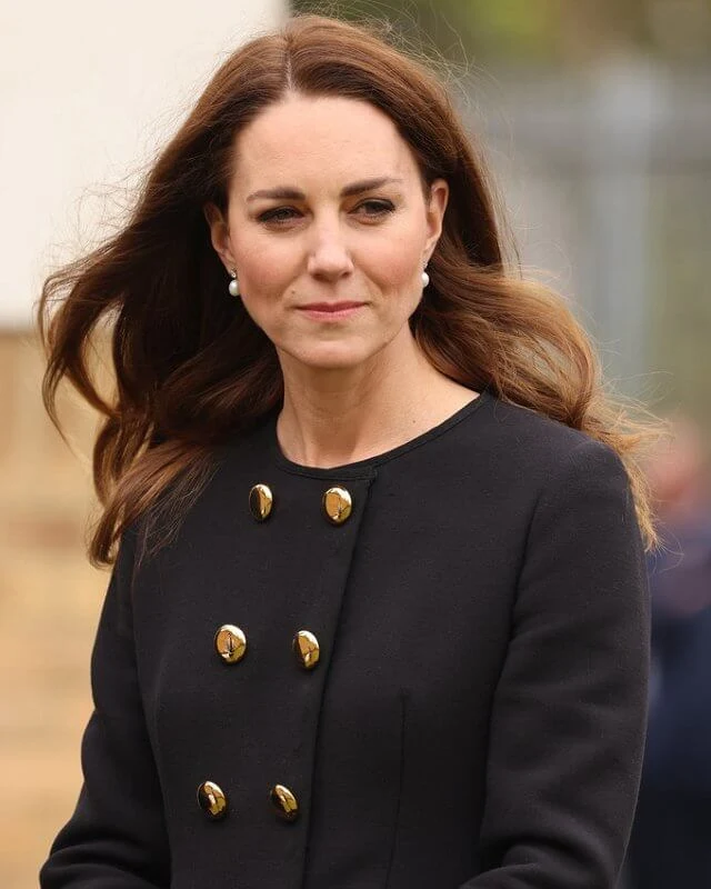 Kate Middleton wore a collarless long coat from Dolce & Gabbana, and suede pumps from Tod's. She carried Mulberry Bayswater clutch