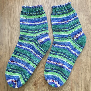 Pair of green and blue hand-knit socks