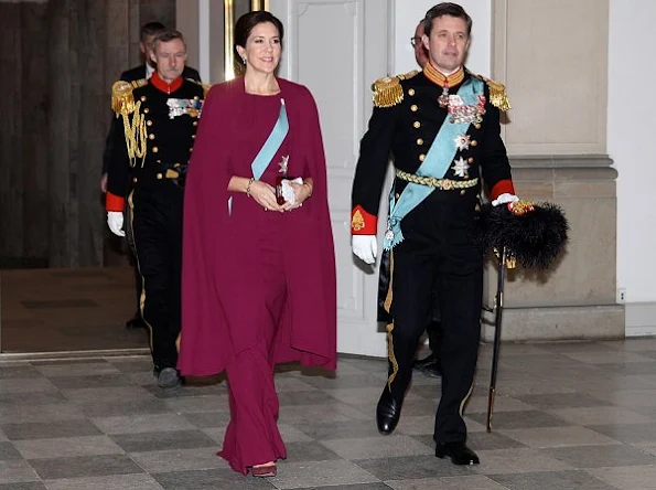 Crown Princess Mary wore red cape, Gianvito Rossi suede pumps, Diamond Tiara, Hugo Boss clutch, Carlend Copenhagen Clutch, diamond earrings, Prada handbags
