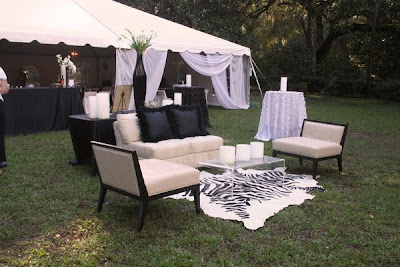 Contemporary outdoor wedding reception lounge with zebra print rug