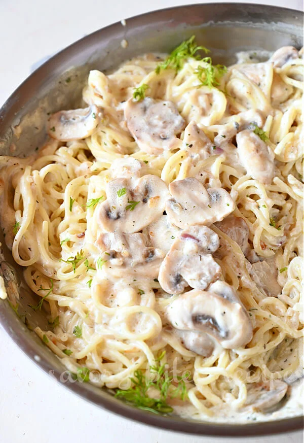 simple mushroom pasta with creamy sauce and topped with chopped parsley