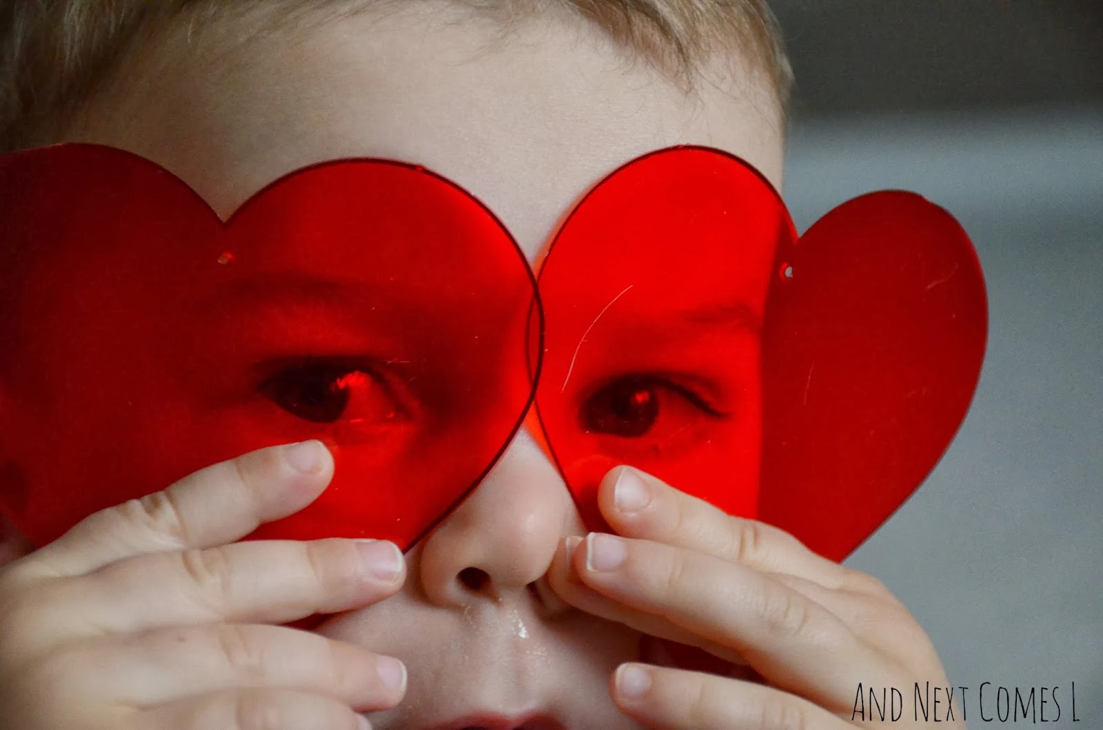 Toddler exploring transparent hearts