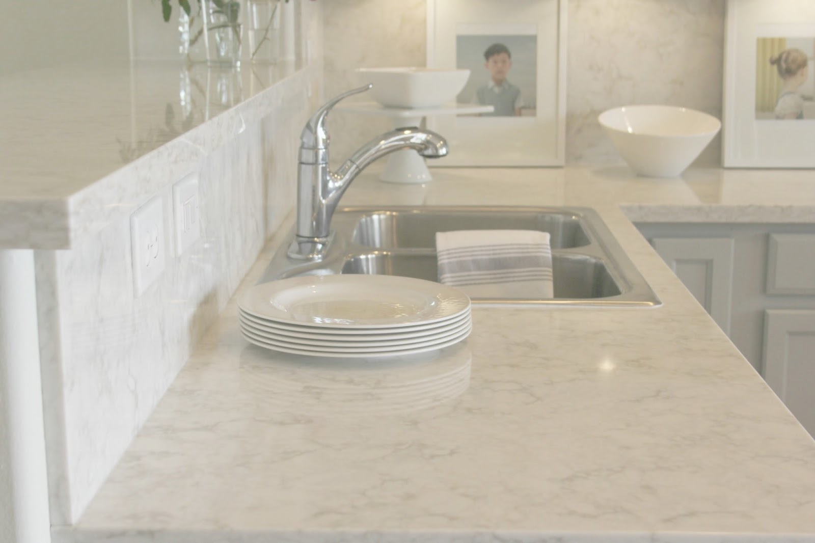 Serene chic simple Nordic French kitchen with grey cabinets and Soprano quartz countertop and backsplash