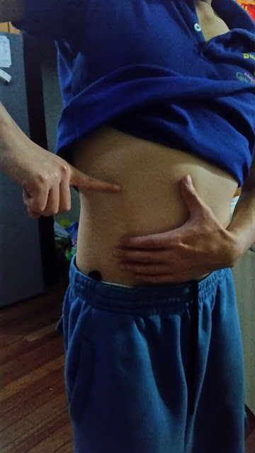 A person's body pointing the location of the liver