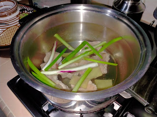 Boil pork ribs, ginger, spring onions for 10 minutes