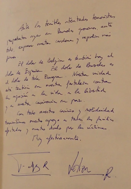 King Felipe signs the book of condolences in the presence of Spanish Queen Letizia and Belgian Ambassador to Spain, Pierre Labouverie,