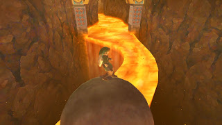 Link walking on a giant, rolling ball over a stream of lava in the Fire Temple