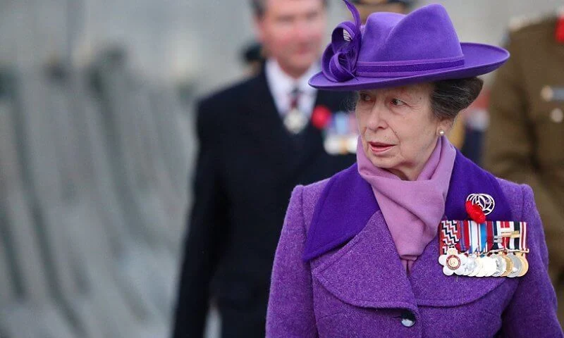 Princess Anne wore an eye-catching purple coat and matching hat, a pale lilac scarf and black knee-high boots