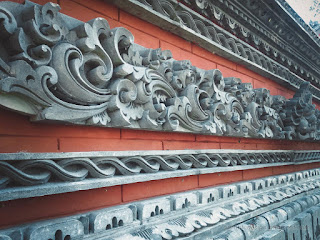 Balinese Wall Building Of The Temple With Ethnic Carvings Style