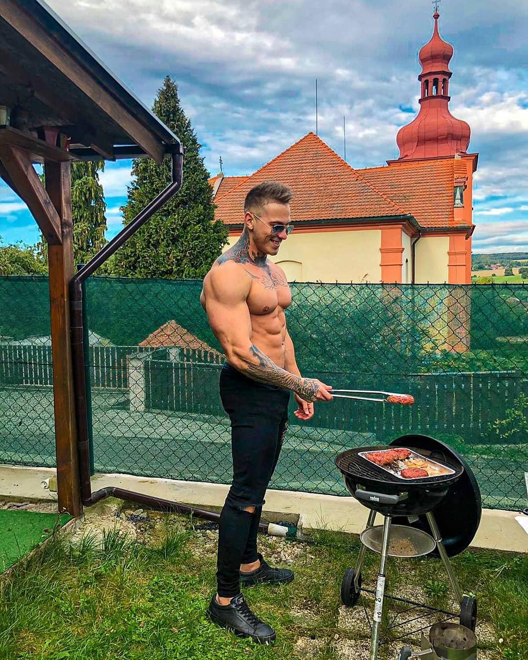 hot-muscle-hunk-bare-chest-huge-pecs-strong-man-grilling-meat