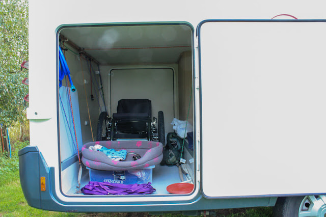 View into the garage at the back, showing my mountain trike and Liggy's bed and long lead.