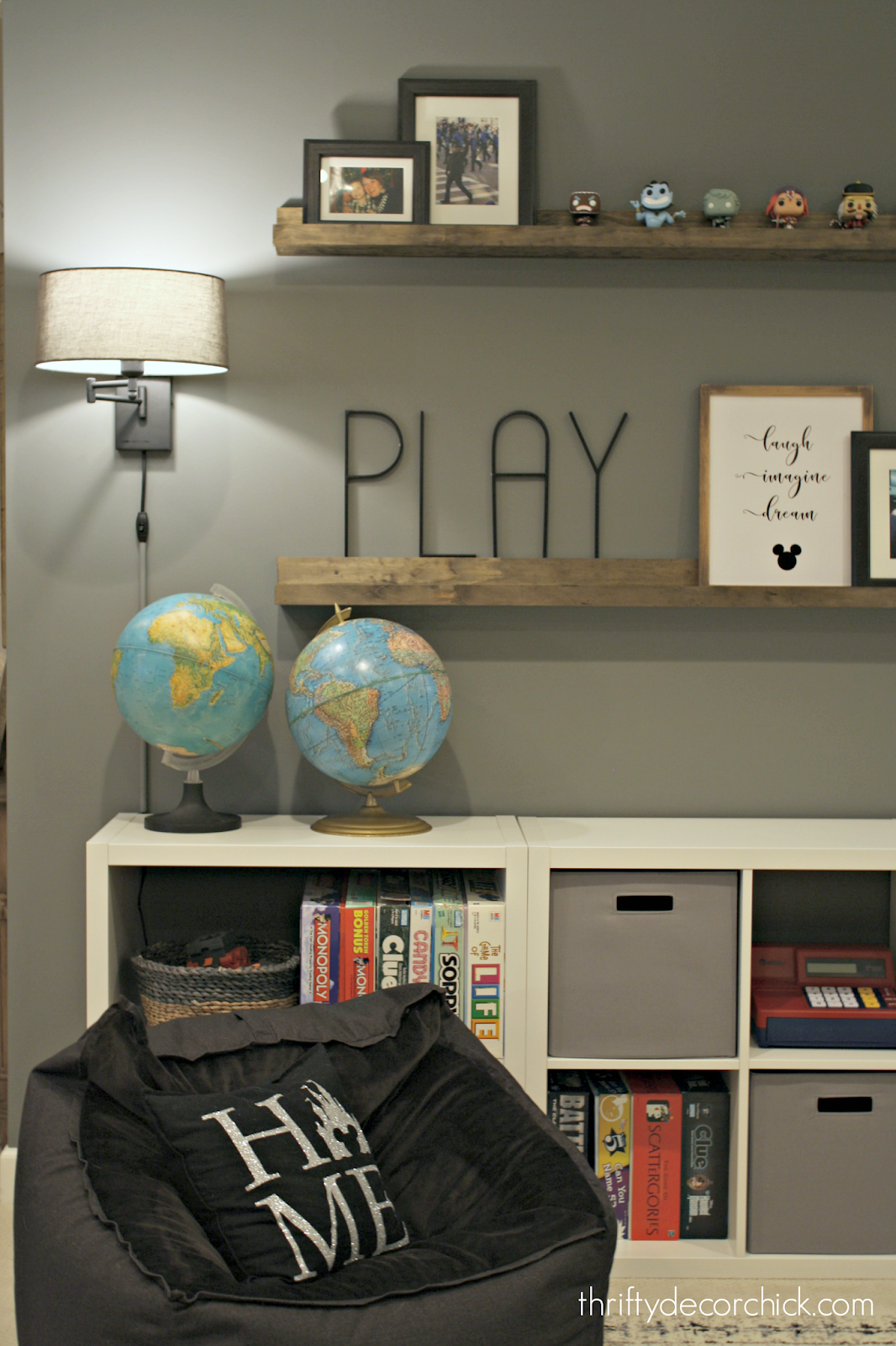 Black skinny PLAY letters on wall