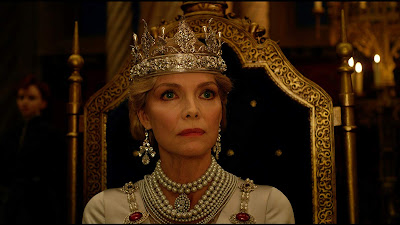 Michelle Pfeiffer's Queen Ingrith dresses in a sparkling white gown and greets Maleficent in a movie scene from the 2019 film Maleficent: Mistress of Evil
