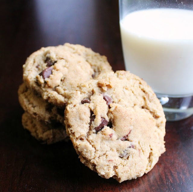 These cowgirl cookies have all the good stuff... brown butter, oatmeal, chocolate and hint of salt. They will make you say yee-haw and grab another! close up of a stack of brown butter cowgirl cookies next to a glass of milk