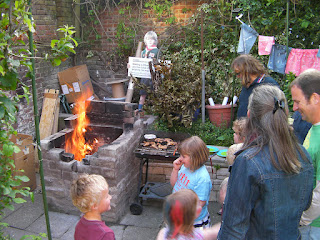 children throwing things onto bonfire