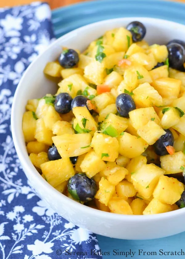 Habanero Pineapple Blueberry Salsa is a Pineapple Salsa kicked up a notch with habanero's, blueberries and chili lime dressing. Delicious party appetizer with chips, on your favorite tacos, over chicken or in breakfast burritos from Serena Bakes Simply From Scratch.