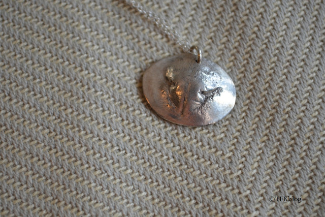 a close up of my cat's nose print necklace