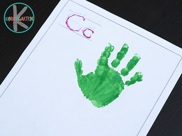 press green painted hand on paper to make the top of the carrot handprint art press green painted hand on paper to make the top of the carrot handprint art
