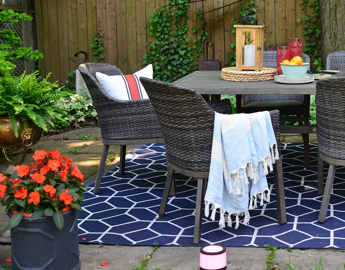 outdoor pillows and throws in basket, outdoor rug, outdoor entertaining, summer party tips
