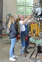 Lyle shows a wine train guest how the radial arm drill press works.