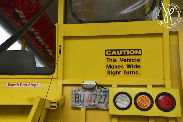 rear portion of vehicle, orange life jackets, warning signs
