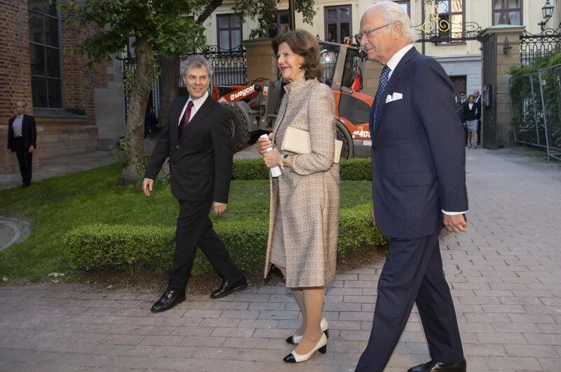 Queen Silvia wore a brown coat and dress from Newhouse Halifax at the Stockholm Early Music Festival 2021
