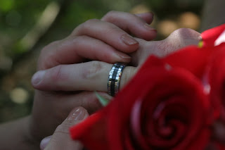 couples hands by roses