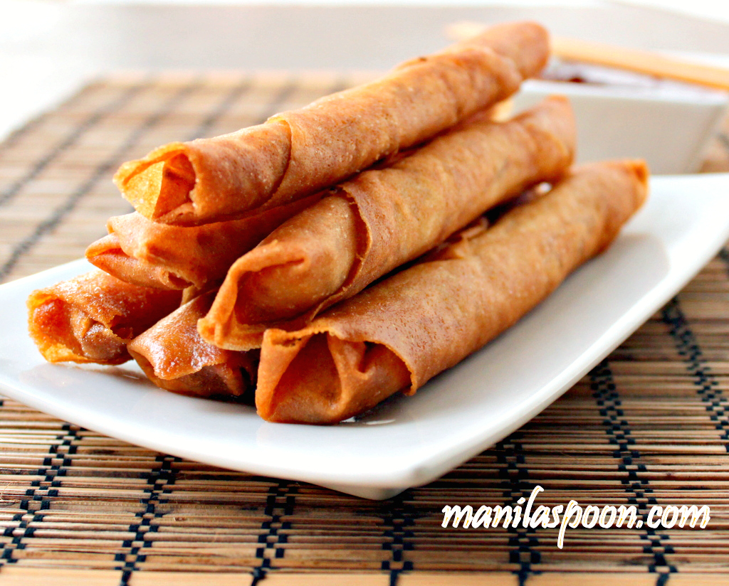 Lumpiang Shanghai or Filipino Spring Rolls are traditionally made of ground meat (usually pork), minced onions, finely chopped carrots and seasoning all rolled up in a paper thin wrapper made with flour and water. It is sealed at the end either by using a sticky beaten egg or plain water. By the name it is given, you can almost guess that it has its origins in China though for some reason we haven't dropped the "Shanghai" at the end and continues to use it to this day. I suppose the reason for this is to differentiate this from the other kind of Lumpia which uses mostly vegetables (though occasionally with a little meat tucked in) as filling. So when you simply say Lumpia, people will tend to think you mean the plumper and bigger spring roll rather than the "Shanghai" which is a smaller and meatier one.