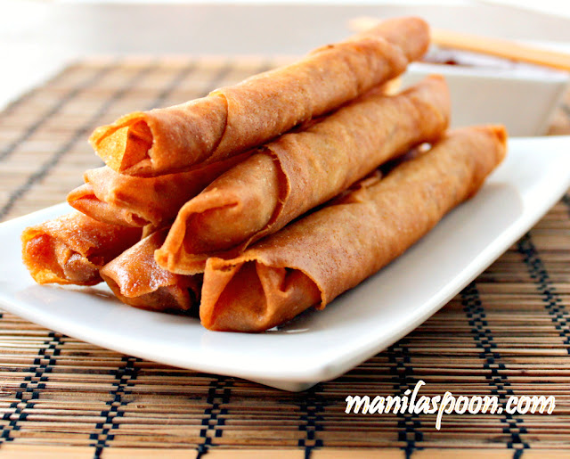 Lumpiang Shanghai or Filipino Spring Rolls are traditionally made of ground meat (usually pork), minced onions, finely chopped carrots and seasoning all rolled up in a paper thin wrapper made with flour and water. It is sealed at the end either by using  a sticky beaten egg or plain water.   By the name it is given, you can almost guess that it has its origins in China though for some reason we haven't dropped the "Shanghai" at the end and continues to use it to this day. I suppose the reason for this is to differentiate this from the other kind of Lumpia which uses mostly vegetables (though occasionally with a little meat tucked in) as filling. So when you simply say Lumpia, people will tend to think you mean the plumper and bigger spring roll rather than the "Shanghai" which is a smaller and meatier one.
