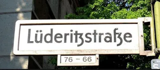 Lüderitzstraße, named after Adolf Lüderitz nicknamed "Lügenfritz" or lie buddy who “bought” land from native Africans until he claimed to own the entire coastal strip from South Africa to Angola, 220,000 sq miles.