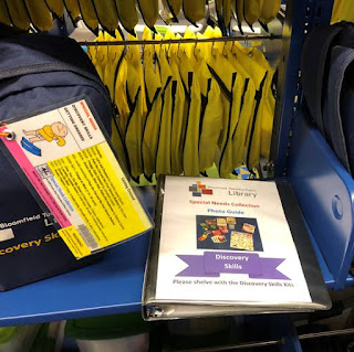 Getting Dressed Discovery Skills Kit backpack and photo guide on top of library shelf