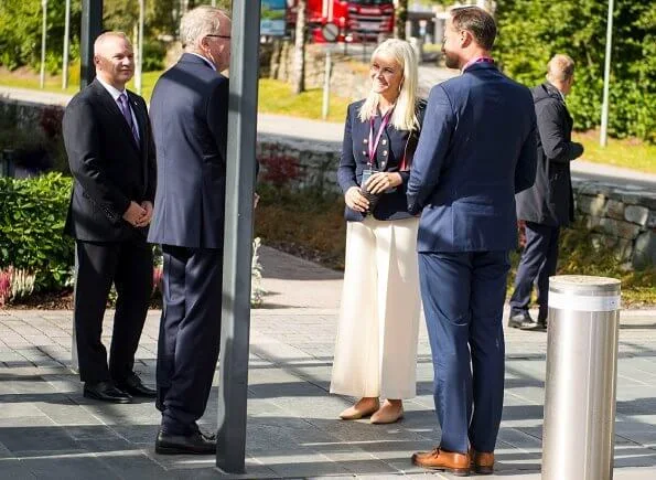 Crown Princess Mette Marit wore a seth double breasted gabardine blazer from Altuzarra, and crepe ivory wide-leg pants from Michael Kors